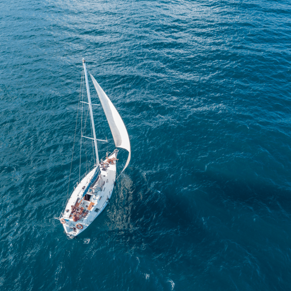 lonely-isolated-yacht-sail-with-tall-mast-going-still-sea-aerial-top-view